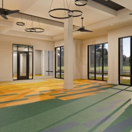 a spacious room with colorful carpet